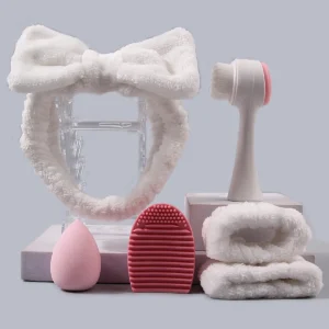 The 6PCS toiletry tool set includes a hairband/wrist strap, a facial cleansing brush, a sponge egg, and a makeup brush cleaner